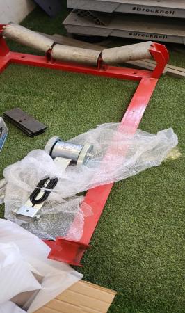 Red belt-scale frame, idlers and sensing components indoors