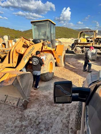Technician inspecting a Hyundai loader at a quarry